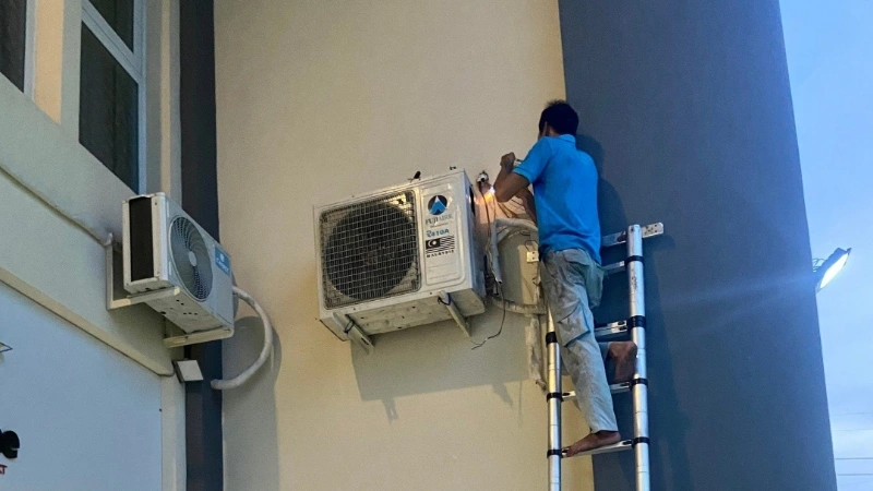 Nhân viên đang vệ sinh dàn nóng ngoài trời